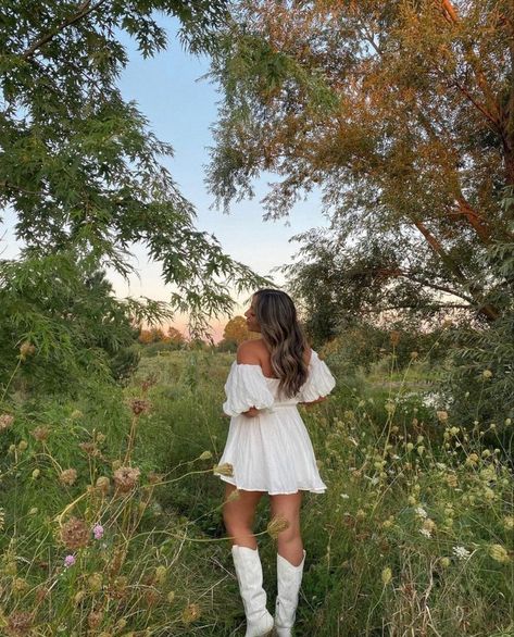 White Dress Country Photoshoot, Short Flowy Dress With Cowboy Boots, White Cowboy Boots Wedding Dress, Senior Pictures With Cowboy Boots, Outfits With White Cowgirl Boots Summer, Sundress And Boots Outfit, Country Outfit White Boots, White Dress With White Cowboy Boots, Plus Size White Cowboy Boots Outfit