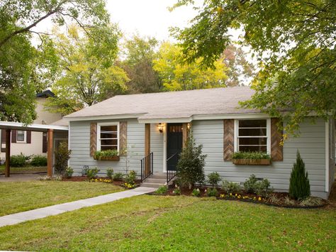 natural wood shutters. doesn't have to have a design like these but I do think it looks cool. and our house is this color. shutter schwing. Light Blue Houses, Hgtv Fixer Upper, Country Ranch, Gray House, Wooden Shutters, Blue Cottage, Shutters Exterior, Exterior Makeover, Ranch Style Homes