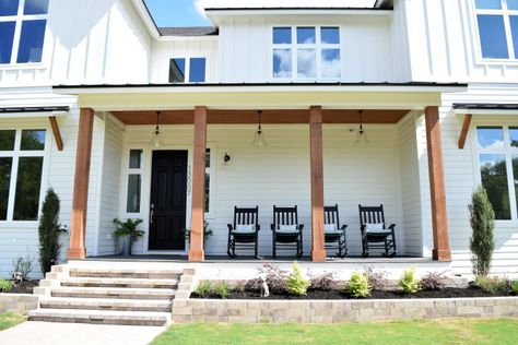 Front porch of white modern farmhouse. Sherwin Williams Tricorn Black front door, Covered Bridge stained cedar posts and tongue and groove porch soffit. Stained Cedar, Building A Custom Home, Tricorn Black, White Modern Farmhouse, Rustic Style Decor, Cedar Posts, House Front Porch, Dream Farmhouse, Building A Porch