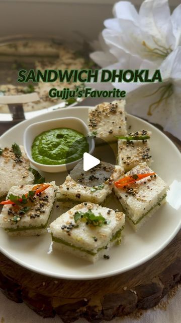 TheKitchenetteStudio on Instagram: "Sandwich Dhokla🤤💚🌿🥪 Gujarati Farsan Recipe 🤤🤤  Sandwich Dhokla is essentially a variation of the traditional dhokla, a savory steamed cake originating from the Indian state of Gujarat. What sets Sandwich Dhokla apart is its layered construction, resembling a sandwich, hence the name.♥️  This dish is not only visually appealing but also bursting with flavor, combining the tanginess of the chutneys with the soft, spongy texture of the dhokla. It’s a beloved snack in Gujarati cuisine, enjoyed as a breakfast item, tea-time treat, or appetizer at parties and gatherings.🎉🌿💚  Ingredients  For green chutney  Coriander leaves with stems  3 green chili  1 inch ginger Salt to taste  1/4 cup peanuts  1 tsp sugar 1/4 tsp cumin powder  1/4 Cup black salt  For Gujarati Farsan Recipe, Gujarati Breakfast Recipes, Gujarati Food Recipes, Tea Time Snacks Indian, Sandwich Dhokla Recipe, Idli Batter, Gujarati Cuisine, Gujarati Snacks, Dhokla Recipe