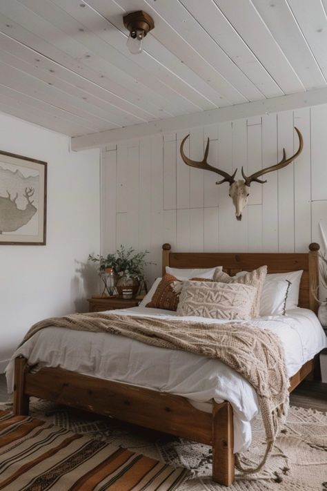 Are you a lover of the great outdoors? Transform your bedroom into a cozy hunting retreat with these rustic decor ideas! Imagine warm wood tones, nature-inspired accents, and unique hunting-themed decor bringing comfort and style together. Perfect for outdoor enthusiasts, you can incorporate fun elements like antler chandeliers and plaid bedding. From wall art featuring wildlife to clever storage that embraces the hunting spirit, discover how to create a personal escape that celebrates your passion for all things rustic and adventurous. Check out these creative ways to bring the hunting vibe home! Hunting And Fishing Home Decor, Deer Skull Above Bed, Antlers Above Bed, Outdoors Bedroom Theme, Country Western Bedroom Ideas, Modern Hunting Decor, Hunter Bedroom Ideas, Hunting Lodge Bedroom, Woodland Bedroom Adult