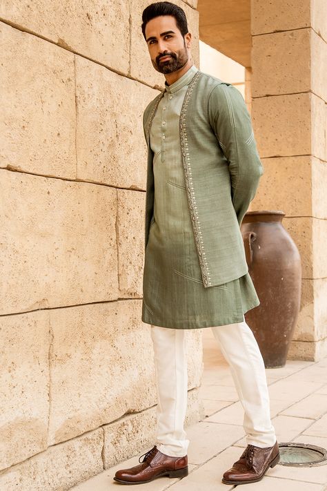 Featuring a pastel pista open jacket in silk base with embroidery. It is paired with a matching kurta and off white box pants.  FIT: True to size.  COMPOSITION: Silk.  CARE: Dry clean only. Kurta Designs Men's, Indo Western Dress For Men, Long Green Jacket, Indo Western For Men, Boys Kurta Design, Wedding Kurta For Men, Wedding Dresses Men Indian, Kurta Men, Kurta Set For Men