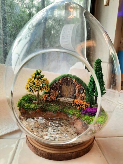 Fairy Garden World | My Hobbit House Fairy Garden Terrarium with waterscape | Facebook Garden Hobbit House, Hobbit Terrarium, Hobbit Hole Decor, House Terrarium, Hobbit Garden, Fairy Garden Terrarium, Garden World, Miniature Landscape, Hobbit House