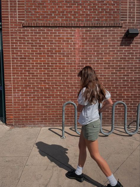 girl in dr martens, green cargo mini skirt and white ruffle shirt walking in front of brick wall Brick Wall Photoshoot Ideas, Brick Wall Photoshoot, Wall Photoshoot, Brick Backdrops, Downtown Aesthetic, Aesthetic Fit, Aesthetic Fits, Ig Feed, Instagram Photo Inspiration