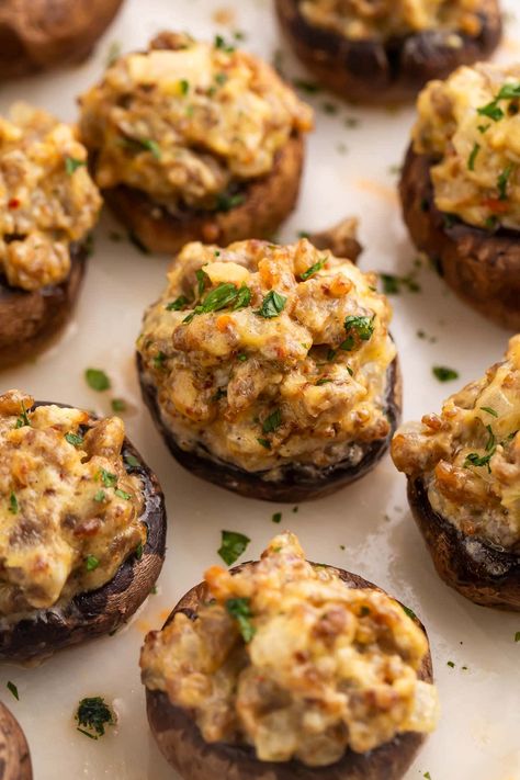 Pass a good time (and some good food) with these party-ready sausage stuffed mushrooms! Greet your guests with a tray of savory, creamy, bite-sized hors d'oeuvres that feel elegant and elevated, but are super easy to make. You might want to be ready with a second tray, though. They disappear fast! Sausage And Cheese Stuffed Mushrooms, Whole 30 Stuffed Mushrooms, Easy Stuffed Mushrooms Sausage, Fancy Stuffed Mushrooms, Stuffed Mushrooms With Sausage Easy, Stuffed Sausage Mushrooms, Stuffed Mushroom Recipes Sausage, Cream Cheese Mushrooms Stuffed, Stuffed Mushroom Appetizers Easy