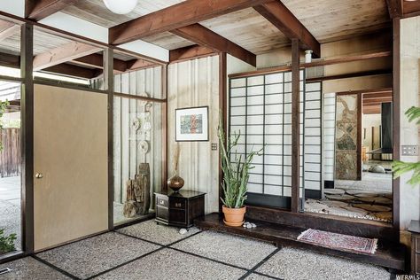 Back in the entryway, a Japanese-style Shoji screen delineates between public and private spaces by separating a hallway that leads to the home's bedrooms. #dwell #realestate #saltlakecity #midcenturymodern 50s House, Japanese Inspired Home, Utah Style, Meditation Studio, Shoji Screen, Backyard Studio, Single Story Homes, Midcentury Home, Mid Century House