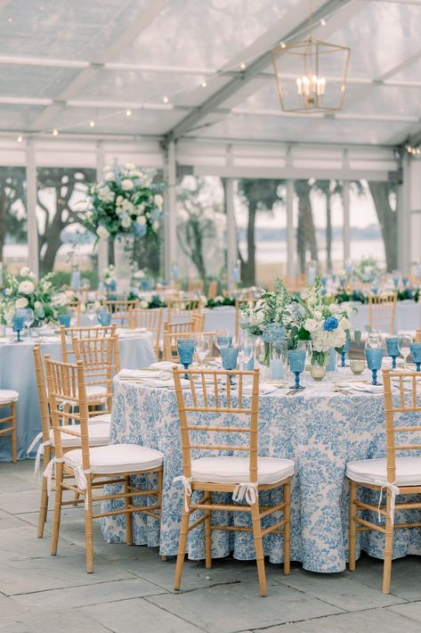 Blue floral table linens with tan chiavari chairs. Blue and white flowers. Blue And Rattan Wedding, Navy And Carolina Blue Wedding, Blue And White Tablecloth Wedding, Classic Blue Wedding Theme, Blue Navy Wedding Theme, Blues And White Wedding, Timeless Coastal Wedding, Blue December Wedding, French Blue And Champagne Wedding