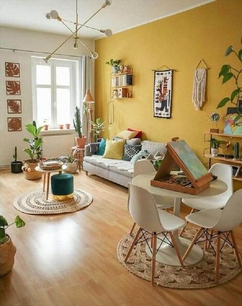 a welcoming boho living room with a mustard wall, neutral furniture, pretty artworks and potted plants Yellow Walls Living Room, Yellow Accent Walls, Patio Art, Deco Chic, Yellow Room, Yellow Living Room, Deco Salon, Yellow Home Decor, Yellow Decor