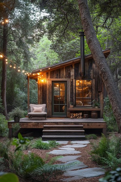 Rustic cabin with warm lights nestled in a forest. Little cabins with less space can equal more joy, laughter, and maybe even a whole new perspective on what “downsizing” truly means. Log Cabin Farm Homes, Interior Yurt Design, Building A Tiny Cabin, Self Built Cabin, Unique Home Spaces, Camping Cabin Interior, Small Lakeside Cabin, Wood Cabin In Forest, Tiny Forest Cabin