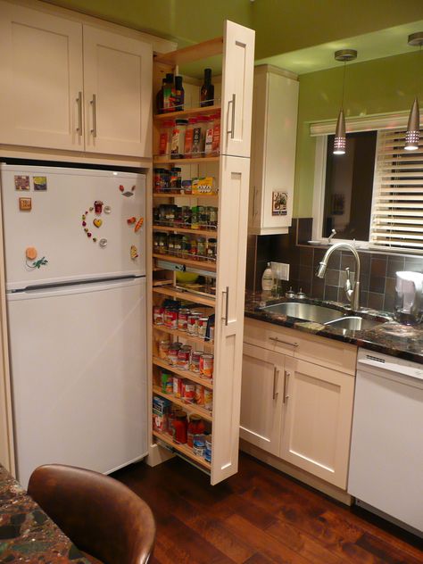 The narrow cabinet beside the fridge pulls out to reveal a spice & canned goods pantry. | Designingspacez Narrow Cabinet Kitchen, Kitchen Towels Storage, Narrow Pantry, Long Narrow Kitchen, Tall Pantry Cabinet, Kitchen Storage Units, Narrow Cabinet, Kitchen Storage Hacks, Narrow Kitchen