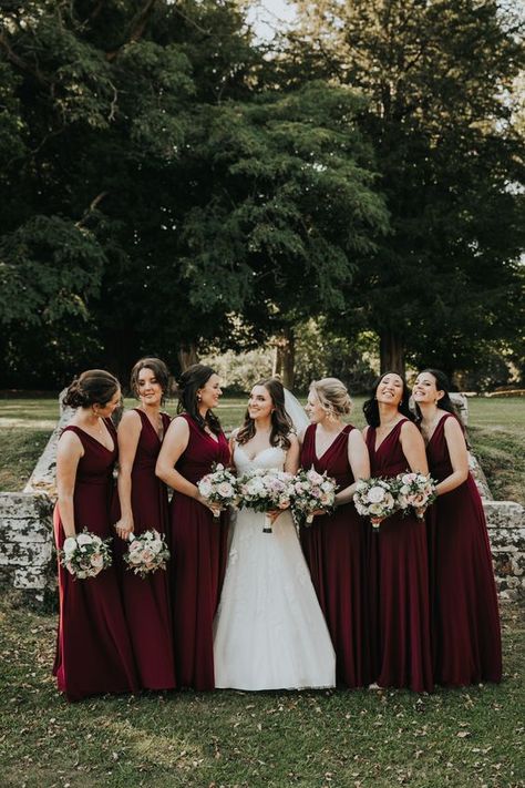 Burgundy and gold for burgundy wedding colors for 2025, burgundy bridesmaid dresses, white bridal gown, burgundy and white flowers and greenery bouquet, table centerpieces, wedding aisle chair décor, gold wedding chairs, white and gold wedding cake and macaroons, burgundy wedding invitations with gold scripts. Wine Colour Bridesmaid Dresses, Burgundy Wine Bridesmaid Dresses, Wine Coloured Bridesmaid Dress, Dark Burgundy Bridesmaid Dresses, Maroon Wedding Aesthetic, Wine Colored Bridesmaid Dresses, Bridesmaid Maroon, Bridesmaid Dresses Maroon, Merlot Bridesmaid Dresses