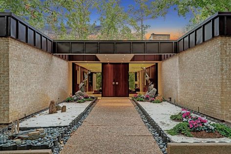 Full-heigh windows wrap around the renovated home, complementing its brick walls. Photo 2 of 10 in The Atrium Is the Star of This $3.1 Million ’70s Texas Home—Or Is It the Conversation Pit? from The Atrium Is the Star of This ’70s Texas Home Asking $3.1M. Browse inspirational photos of modern homes. Atrium House, Conversation Pit, Brick Walls, Texas Real Estate, Texas Homes, Modern Homes, Brick Wall, 1 Million, The Star