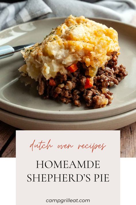 A serving of shepherd's pie on a plate. Shepherds Pie Dutch Oven, Dutch Oven Shepherds Pie Recipe, Dutch Oven Dinner Recipes For Camping, Dutch Oven Stew Camping, Camping Stew Dutch Ovens, Cheesy Garlic Mashed Potatoes, Homemade Shepherd's Pie, Easy Camping Dinners, Dutch Oven Beef