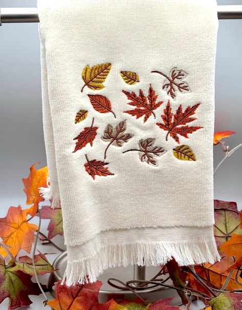 Crunchy leaves, cooler temps, pumpkin spice, its time for Fall! This 18" x 11" fingertip towel is great for your car, bathroom, grill or anywhere you need it. Absorbent for spills or wet hands.  Perfect for gift giving or to give to yourself! The towel is embroidered meaning it is stitched onto the towel for greater durability and years of use Be sure to favorite NanaBee's Embroidery for fast, beautiful gifts or home decor This item was created in a smoke free and pet free environment. Washing instructions: machine wash warm, tumble dry warm PROCESSING TIME IS 2-4 DAYS. THIS DOES NOT INCLUDE SHIPPING TIME WHICH IS 3-5 DAYS Fall Hand Towels, Embroidery Towels Ideas, Embroidered Kitchen Towels, Car Bathroom, Crunchy Leaves, Ready For Autumn, Wet Hands, Halloween Embroidery Designs, Happy Pumpkin