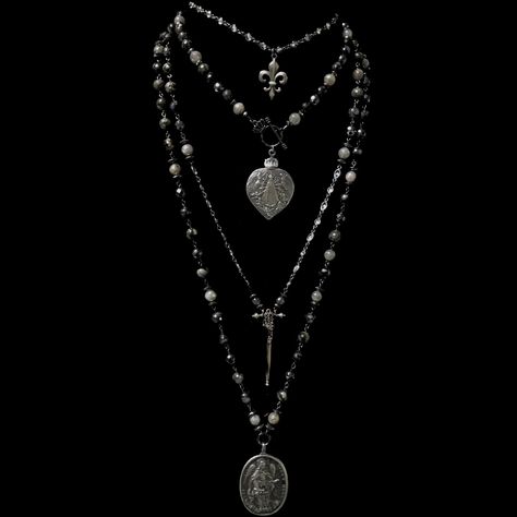 The Lujan Choker features an intricately carved Our Lady of Lujan medal within a flaming Sacred Heart made of Sterling Silver. She's surrounded by Angels, with two of them raising a crown of flowers above her. Pilgrims worldwide travel to see Her and have received special graces, favors and miracles. The gunmetal linked chain is offered in 17" or 22" based on your preference. If you need a longer or shorter size we can make one for you. It's a very special necklace because of the rarity of the m Statement Necklace Long, Silver And Black Necklace, Silver Gothic Jewelry, Trad Goth Jewelry, Ecclesia Jewelry, Long Necklace Outfit, Long Beaded Necklaces, Surrounded By Angels, Goth Jewellery