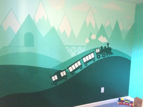 I painted this train mural for my son's bedroom. He's really in to trains and I wanted to do something that will last beyond the Thomas phase. I painted this all by hand, I didn't use any tape. I created the image in Illustrator, and then projected my illustrator file onto his wall and traced it. Then it was just a matter of a steady hand and using a variety of bushes and rollers. Train Murals Wall Art, Train Wall Mural, Train Bedroom For Boys, Train Playroom, Train Mural, Train Bedroom, Craft Booth Design, Boys Room Mural, Train Nursery