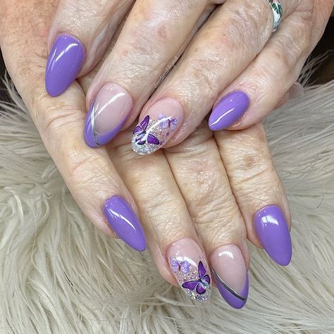 Beautiful almond shape nails with purple and glitter fade with purple butterflies Blue And Purple Almond Nails, Purple Butterfly Nails Almond, Speak Now Nails Taylor Swift Purple, Purple Nail Inspo Acrylic Short Almond, Purple Almond Nail Ideas, Purple Butterfly Nail Designs, Purple Butterfly Acrylic Nails, Olivia Rodrigo Nail Inspo Guts, Olivia Rodrigo Nails Ideas