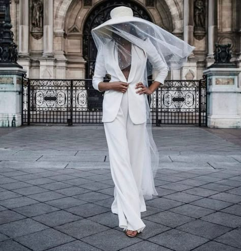 Channel your inner Bianca Jagger with this custom all-white bridal outfit from Alicia Rueda. The bridal hat paired with a pearl-embellished veil, flowing pants, and fitted blazer is just the look all modern brides would love for their chic city wedding or elopement. Find more trendy bridal hats at the link. // Photo: Xabi Vide Fotografia Wedding Trouser Suits, Bridal Hats, Blazer Wedding, City Bride, Bride Hat, Bridal Hat, Trouser Suit, Bridal Outfit, Bride Headpiece