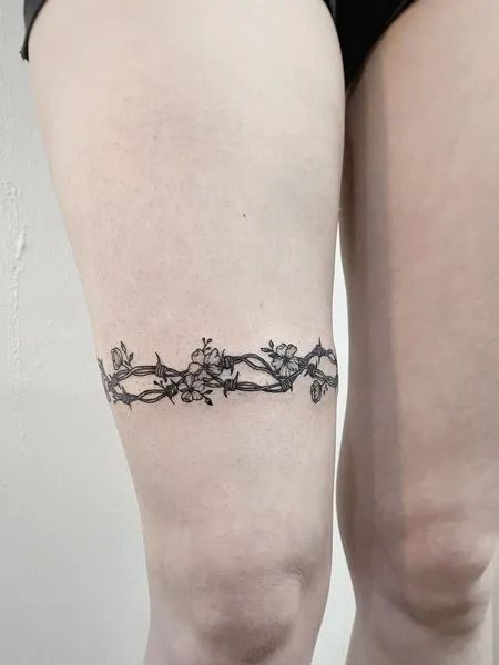 35 Best Barbed Wire Tattoos For Men And Women - Tattoo Pro Barbwire With Flowers Tattoo, Barb Wire Vine Tattoo, Barbed Wire Hip Tattoo, Flower Barbed Wire Tattoo, Floral Barbed Wire Tattoo, Barbwire Tattoo Thigh, Barb Wire Flower Tattoo, Barb Wire Wrist Tattoo, Thigh Bracelet Tattoo