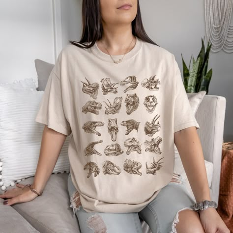 This Dinosaur Tshirt is a perfect dinosaur gift for dinosaur lovers likes tyrannosaurus rex T-Rex, Carnotaurus, Mosasaurus and velociraptor. Perfect to wear at fossil hunting, museums trips or a dinosaur theme birthday parties. For other dinosaur items, click here: https://www.etsy.com/shop/TheNims?search_query=dinosaur Browse through my other awesome items here: http://thenims.etsy.com/ ABOUT THE PRODUCT: UNISEX TEES Gildan 5000™ (CUSTOMER FAVORITE) * 100% Cotton (fiber content may vary for dif Womens Dinosaur Shirt, Dinosaur Shirt Women, Gifts For Dinosaur Lovers, Dinosaur Outfit Women, Dinosaur T Shirt, Dinosaur Shirt Ideas, Dino Clothes, Dinosaur Things, Dinosaur Clothes