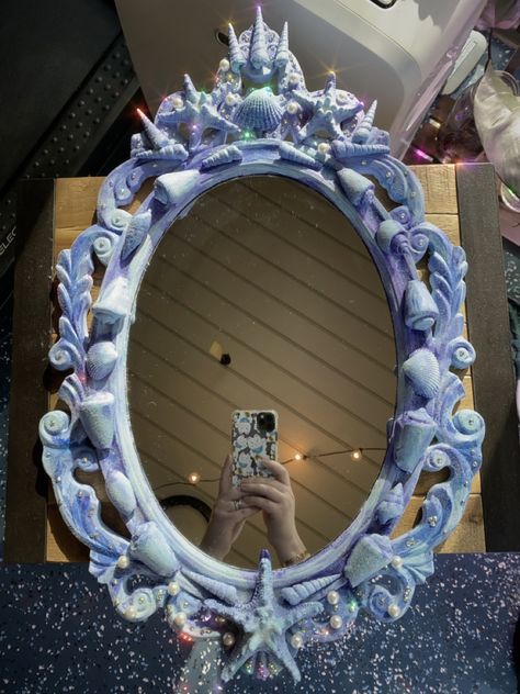 A multicolor mirror decorated with shells, pearls, and crystals sparkles with a mermaid theme. Mermaid Mirror, Funky Mirrors, Mermaid Pool Parties, Glitter Mirror, Unicorn Spit, Mermaid Crafts, Mirror Makeover, Mermaid Shell, Mermaid Diy