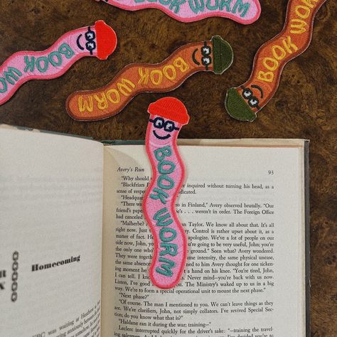 Add a touch of whimsy to your reading experience with our Bookworm Bookmark Patch. This adorable embroidered bookmark features a cheerful worm wearing a cowboy hat, perfect for book lovers and anyone who appreciates cute and quirky accessories. Key Features: Adorable Design: A charming and playful illustration of a bookworm. Versatile Use: Can be used as a bookmark or a sew-on patch. Measures Approx 5" x 2": The perfect size for most books. High-Quality Embroidery: Crafted with professional-grad Book Worm Bookmark, Book Worm Illustration, Felt Book Ornament, Bookmark Craft Diy, Hand Drawn Bookmarks, Stained Glass Bookmark, Sew Bookmark, Embroidered Book Cover, Felt Book Marks