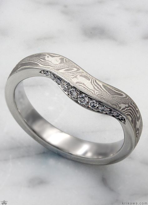 This wedding band stands out on its own with its one-of-a-kind pattern of mokume. Complimenting the natural pattern of the mokume, the band has a beautiful contoured curve. At the heart of this ring, a collection of bead-set stones adds a little shimmer to your day. The contoured shape of this wedding band makes it perfect to compliment any engagement ring. Mokume Gane Ring Wedding, Mokume Gane Ring, Mokume Gane, Bead Set, Diamond Wedding Band, Patterns In Nature, Ring Wedding, The Natural, Diamond Wedding Bands