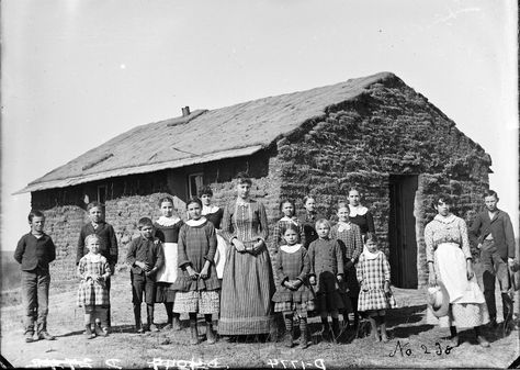 Circa 1889. Sod school, District 62, 2 miles west of Merna, Custer County, Nebraska. Teacher identified as Elsie Thomas, who later married a Mr. Bidgood. The girls in the back row, second to the left of the teacher is Nettie Hannawald. Solomon D. Butcher Nebraska State Historical Society, [Digital ID: nbhips 11996] www.loc.gov #American #History #Nebraska American Pioneers, Photo Of People, Pioneer Days, Pioneer Families, Pioneer Life, Country School, Small Building, The Oregon Trail, Old School House