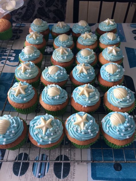 Ocean cupcakes with white chocolate shells and starfish. Pearls and glitter too for added wow factor! Merryn's Under The Sea / Ariel /Mermaid party Ocean Theme Cupcakes Kids, Beach Cupcakes Ocean Themes, Under The Sea Cupcake Ideas, Beachy Cupcakes, Starfish Cupcakes, Ariel Mermaid Party, Ocean Themed Cupcakes, Under The Sea Cupcakes, Ocean Cupcakes