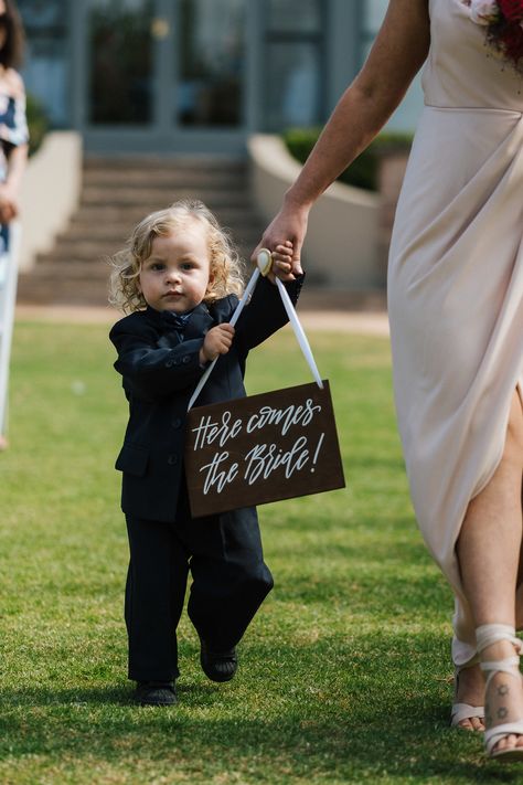 Page Boy carrying Here Comes the Bride sign #cute #pageboy #herecomesthebride PC: Euphoria Films Here Comes The Bride Sign, Bride Sign, Wedding 2025, Flower Boys, Here Comes The Bride, Here Comes, Wedding Inspo, The Bride, Wild Flowers