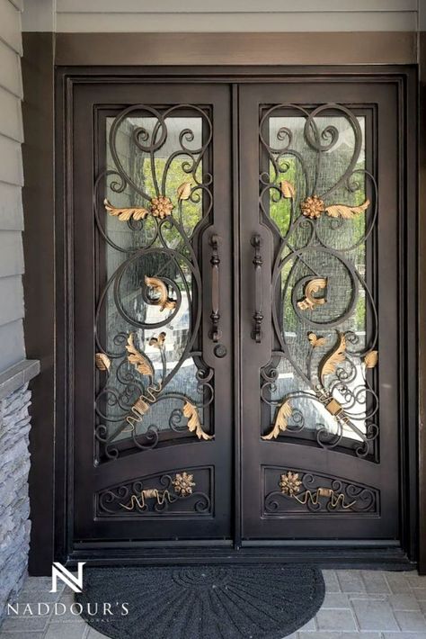 Dark bronze iron door with scrolling and gold accents. Iron Door Design Front Entry, Wrought Iron Door Inserts, Wrought Iron Front Door, Window Grill Design Modern, Iron Front Door, Iron Entry Doors, Iron Door Design, Double Entry Doors, Window Grill Design