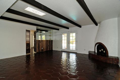 love the hexagon Saltillo tiles and kiva fireplace. Dark beams and white paint. Staining Terracotta Tiles, Dark Beams, Fireplace Dark, Saltillo Floor, Farmhouse Bathroom Light, Mexican Tile Floor, Painting Light Fixtures, Western Bathroom Decor, Spanish Style Kitchen