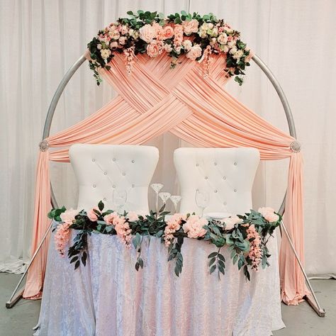 Today I worked on dressing up our Circle Arch with some blush pink spandex drapes and silk floral to compliment this gorgeous sweetheart table setup! Circle Arch With Drape, Round Arch Draping, Circle Backdrop With Drapes, Wedding Arch Drapery Ideas, Round Wedding Arch Draping, Circle Wedding Arch With Drape, Decorating Ideas Wedding, Circle Arch Backdrop, Wedding Decoration Idea