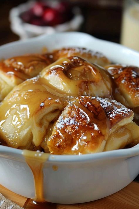 Apple dumplings served with a drizzle of cinnamon sugar sauce Hot Apple Dumplings, Pioneer Woman Apple Dumplings, Slice Of Heaven Cake, Heaven Cake, Easy Apple Dumplings, Cinnamon Sugar Apples, Apple Dumpling Recipe, Stuff To Bake, American Dessert