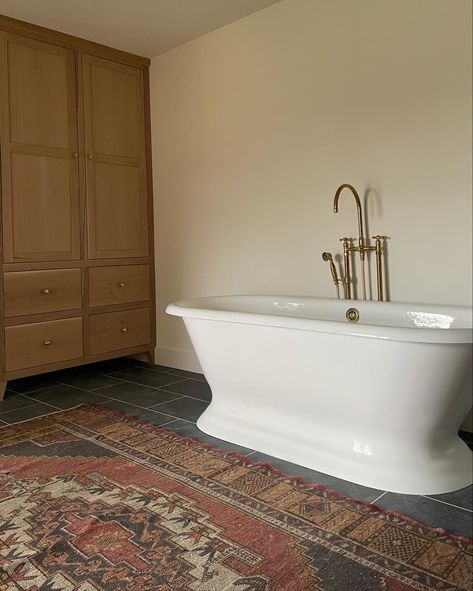 freestanding bath tub, bathroom renovation, custom cabinets, stone floor, vintage rug Porcelain Tile Bathroom, Pedestal Tub, Atlas Concorde, Primary Bath, Bath Renovation, Primary Bathroom, Bath Sinks, Stone Look Tile, Love And Co