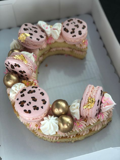 Two layer cake shaped as the letter “C”. It is pink themed and has cheetah print macarons, gold round chocolates, meringues and pink sprinkles. Bougie Cake Ideas, C Cake Letter, Princess Wedding Cakes, Letter Cakes, Cake Number, Cake Lettering, Recipes For Baking, Decorative Food, Letter Cake