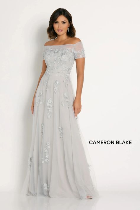 Cameron Blake #CB751. Description: 
                        Featuring a seductive off-the-shoulder neckline with elegant short sleeves, this gown is both timeless and flattering. The softly structured bodice, adorned with dazzling beads and sparkling stones, radiates luxury, while the cascading skirt with tulle overlay creates gorgeous movement with every step.
                    . Details: Fabric: Beading, Sequin, Stone Accents, Tulle;Length: Long;Neckline: Off-the-Shoulder;Silhouette: A-Line; Cameron Blake, Off Shoulder Evening Gown, Evening Gowns With Sleeves, Mother Of Groom Dresses, Fabric Applique, Evening Dresses For Weddings, Tulle Gown, Mon Cheri, Embroidered Details