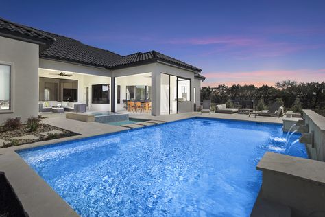 This beautiful, contemporary pool features a glass tiled, negative edge spa, raised flagstone scupper wall, planter pedestals, stepping stones and ample decking for a splendid space to entertain or relax. Plaster by Pebble Technology: White Pearl Luxury Swimming Pools, Pool Builders, Custom Pools, Pool Designs, Outdoor Design, Glass Tile, San Antonio, Stepping Stones, Swimming Pools