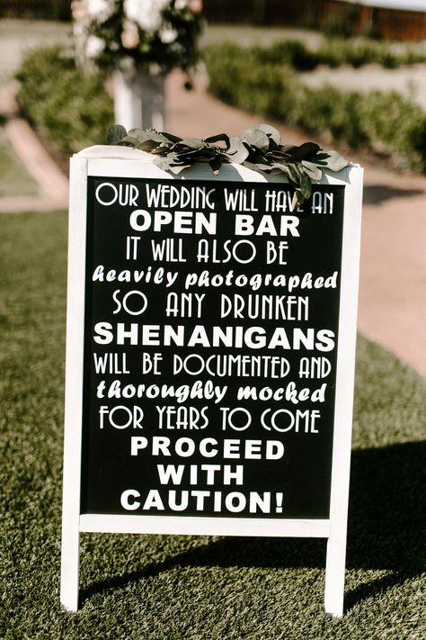 | wedding reception sign | wedding bar sign | "our wedding will have an open bar.  it will also be heavily photographed so any drunken shenanigans will be documented and thoroughly mocked for years to come.  proceed with caution!" | funny wedding signs |  photo taken at THE SPRINGS Event Venue. follow this pin to our website for more information, or to book your free tour! SPRINGS location:  Tuscany Hill in McKinney, TX photographer:  Local Embers & Co. #weddingsign #weddingreception #weddingday Fall Wedding Bar, Wedding Bar Signs, Wedding Reception Party Favors, Funny Wedding Signs, Funny Bar Signs, Wedding Reception Hall, Planning A Small Wedding, Reception Sign, Dallas Wedding Venues