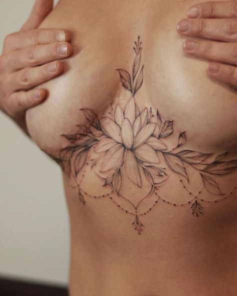 Breast tattoos are a beautiful way to express yourself and your individuality. These 40+ designs are sure to steal your heart in 2023. Looking for your next tattoo design? Check out our extensive collection of tattoo sketches and find your perfect match!#tattoo #tats #tattoo_desing#female_chest_tattoos #chest_tattoos #chest_floral_tattoo Chest Tattoo Female Underboob, Breast Lift Scar Tattoo, Lotus Sternum Tattoo Women, Breast Lift Tattoo Cover Up, Underboob Mandala Tattoo, Mid Chest Tattoo Female, Shoulder Tattoos For Women Unique, Women Sternum Tattoo, Mandala Sternum Tattoo