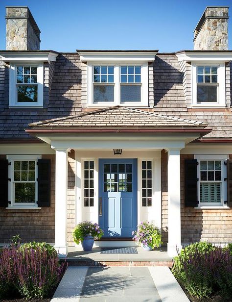 Cape cod style home with a blue front door and lovely porch decorated with planters and a black lantern. Cottage Home Exterior, Cape Cod Exterior, Cape Cod House Exterior, Cottage House Exterior, Portico Design, Patrick Ahearn Architect, Patrick Ahearn, Front Door Ideas, Cape Cod Cottage