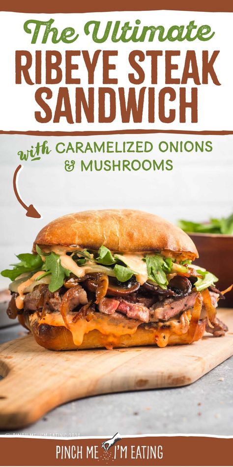 This grilled ribeye steak sandwich is loaded with roasted red pepper garlic aioli, arugula, provolone, caramelized onions, and mushrooms, all on a toasty ciabatta roll. You can even use thinly sliced leftover steak in this recipe! This sandwich is a great main course dish, and the sauce is out of this world! Steak Sandwich With Garlic Aioli, Ribeye Sandwich Recipe, Grilled Steak Sandwich, Ribeye Steak Sandwich, Caramelized Onions And Mushrooms, Steak Sandwich Recipes, Grilled Ribeye Steak, Ciabatta Roll, Grilled Ribeye