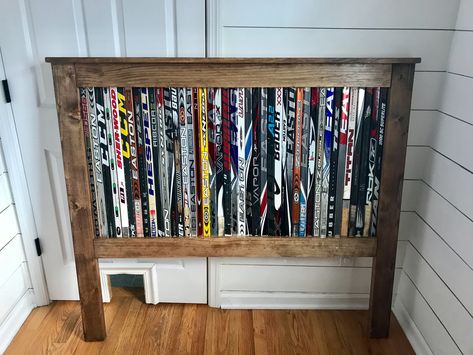 Hockey Stick Headboard Diy, Hockey Playroom, Hockey Stick Headboard, Hockey Stick Garage Storage, Mini Hockey Stick Storage, Diy Hockey Stick Projects, Hockey Room Ideas, Hockey Stick Decor, Hockey Bedroom Ideas