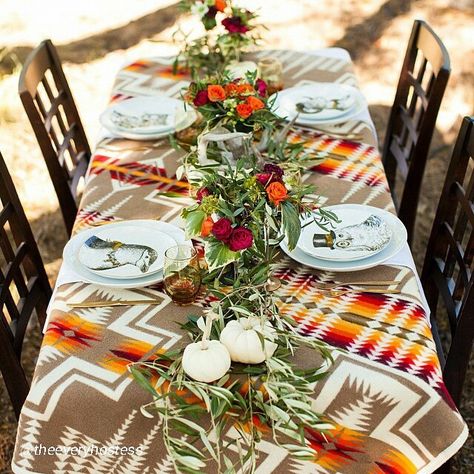 An interesting use of a Pendleton Chief Joseph wool blanket. You can find Pendleton blankets at Sheepskin of Oregon in downtown Portland Oregon, or at www.sheepskinoforegon.com Fall Harvest Dinner, Harvest Dinner Party, Native American Thanksgiving, Navajo Wedding, Harvest Dinner, Native American Wedding, Southwest Wedding, Pendleton Woolen Mills, Lodge Decor