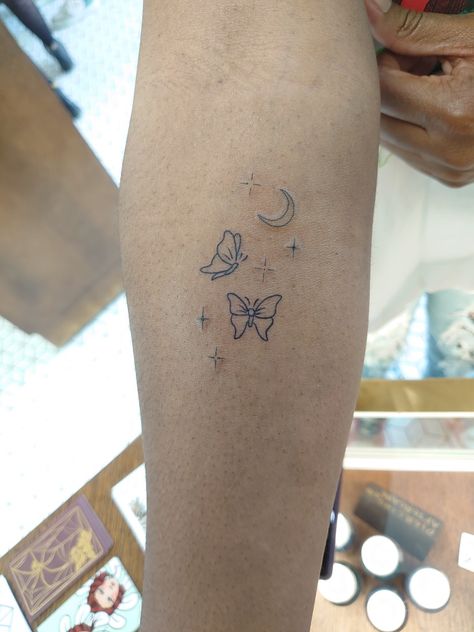 Lined butterflies tattoo with moon and stars Moon Star Butterfly Tattoo, Butterfly Moon Stars Tattoo, Dainty Earthy Tattoos, Space Butterfly Tattoo, Moon Tattoo Placement Ideas, Butterfly And Star Tattoo, Butterfly And Stars Tattoo, Moon And Butterfly Tattoo, Moon Butterfly Tattoo