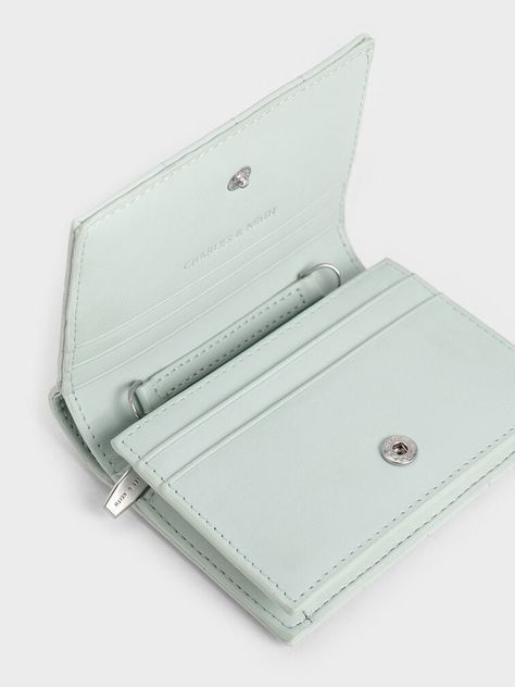 Wallets are great starter pieces to start introducing more colours into your wardrobe. The ultra-compact silhouette of this sage-green wallet is paired with plush and padded square quilts for a touch of tactility to create a soft design that is a treat to use every day. Generously sized for multiple cards and folded note bills, slot it into your everyday bags or attach the delicate chain strap to convert it into a micro bag. Square Quilts, Folded Note, Micro Bag, Soft Design, Mini Accessories, Charles Keith, Delicate Chain, Mini Wallet, Everyday Bag