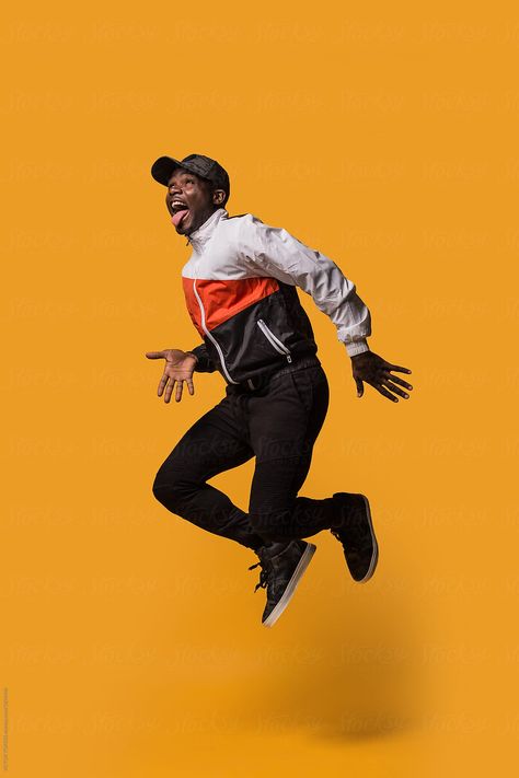 Stylish sporty man jumping over a yellow background by VICTOR TORRES for Stocksy United Jump Art, Man Jumping, Studio Photography Fashion, Ritter Sport, Portrait Photography Men, Photography Poses For Men, Male Poses, Studio Shoot, Character Poses