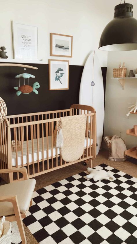 Surf-inspired nursery with a black-and-white checkered rug, wood crib, coastal decor, and a modern, adventurous vibe. Polynesian Nursery, Baby Boy Beach Nursery, Surf Nursery Theme, Coastal Baby Room, Nursery Ideas White Walls, Beachy Nursery, Checkered Nursery, Surfer Nursery, Neutral Nursery Ideas