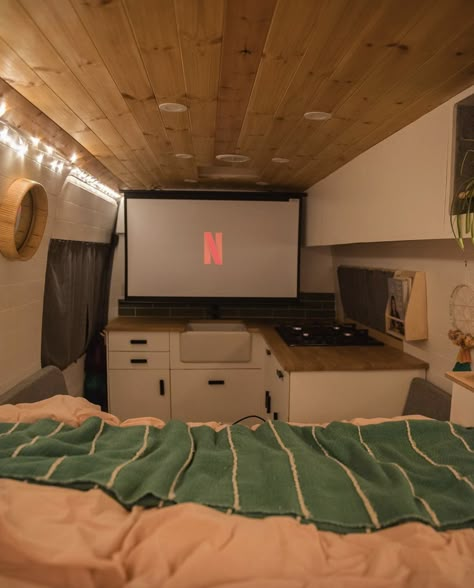 If you are planning on living in your van full time, a projector is a great way of being able to watch movies. The essence of van life is to switch off a bit and enjoy nature and the outdoors, but if you're living in your van, chances are there might be some rainy days when you won't complain about having a projector! This post details how to have a projector in a van conversion. Watching Movies In Bed, Van Renovation, Nomadic Living, Projector Setup, Van Layout, Kombi Motorhome, Camper Interior Design, Tenda Camping, Bus Living