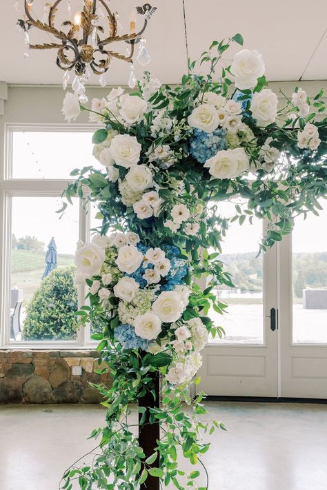 A dreamy white and blue floral design| wedding flowers,flowers for wedding,floral wedding,flower arrangements,floral installation,floral inspiration,event floral design,floral details,wedding flowers,wedding ceremony,wedding ceremony decoration,wedding ceremony decor ideas,elegant wedding,wedding details,wedding stuff,wedding decorations,elegant wedding decro ideas,wedding planning,wedding stylist,wedding florist,indoor wedding,indoor wedding ceremony,2022 wedding,winter wedding White And Blue Arch Wedding, Blue And White Wedding Arbor, Blue White Sage Wedding, Blue And White Floral Arch, White And Green Florals For Wedding, Blue Ceremony Arch, White And Blue Wedding Arch, Blue And White Wedding Arch, White Floral Installation